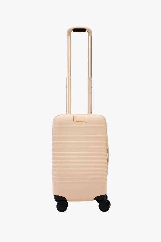 Compact carry - on travel bag with spinner wheels for easy maneuvering in airportsThe Small Carry-On Roller in Beige