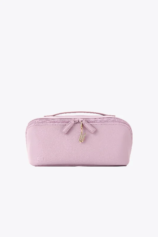 Compact carry - on travel bag with spinner wheels for easy maneuvering in airportsThe Wicked Toiletry Kit in Wicked Pink